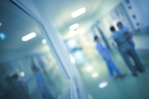 Three Medical Professional&apos;s talking in Hallway